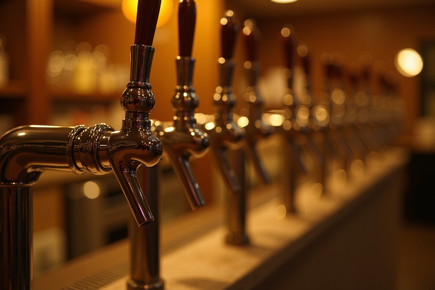Row of clean beer taps in a bar